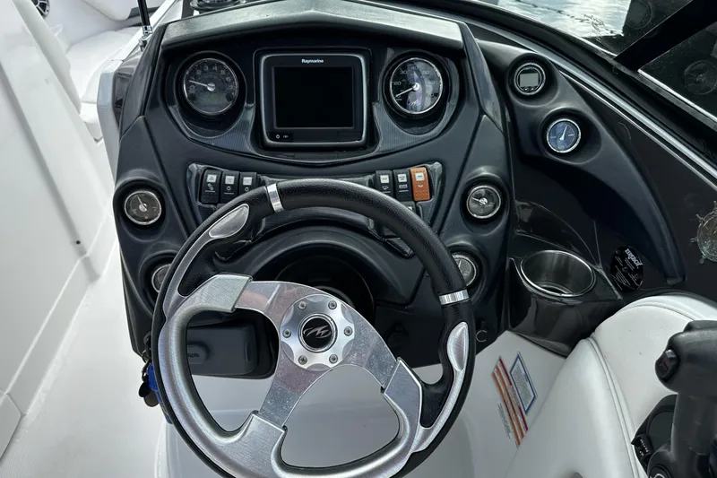 Slide: The Image of Steering wheel and dashboard of 2015 Monterey 264FS boat with gauges and controls. - 21