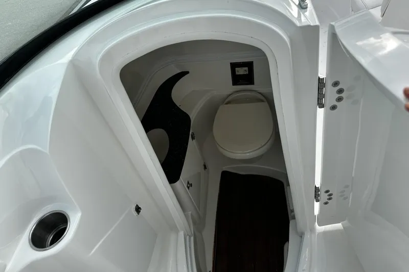 Slide: The Image of 2015 Monterey 264FS boat interior with compact bathroom and toilet. - 25