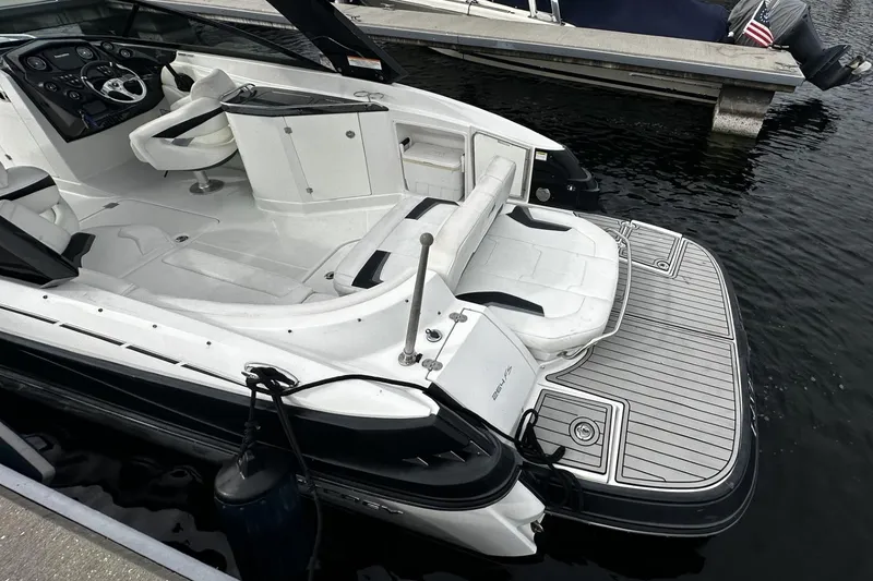 Slide: The Image of 2015 Monterey 264FS boat with sleek interior and spacious deck at a marina. - 28