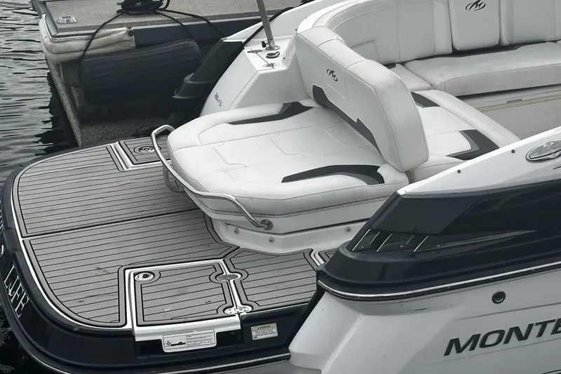 Slide: The Image of 2015 Monterey 264FS boat with sleek seating and swim platform at dock. - 29