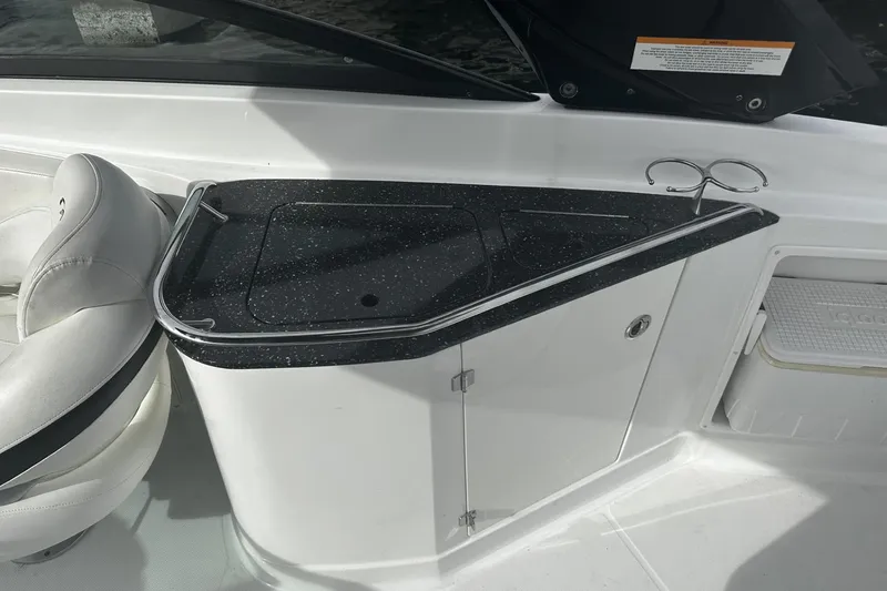 Slide: The Image of 2015 Monterey 264FS boat interior with black countertop and white seating. - 31