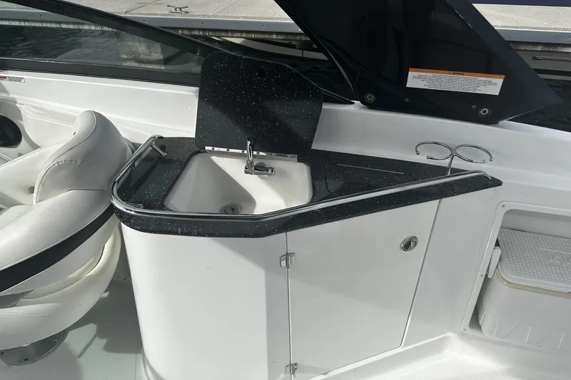 Slide: The Image of 2015 Monterey 264FS boat interior with sink and seating area. - 32