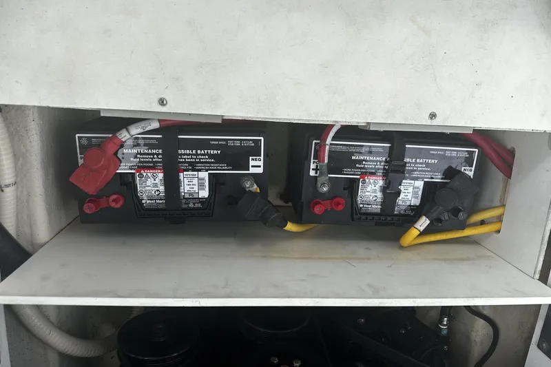 Slide: The Image of Two maintenance-free batteries in a 2015 Monterey 264FS boat compartment. - 34