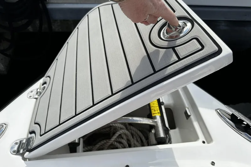 Slide: The Image of Person opening storage compartment on 2015 Monterey 264FS boat. - 35