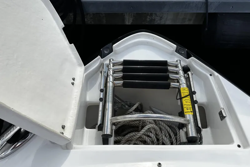 Slide: The Image of Open storage compartment on 2015 Monterey 264FS boat with ladder and rope. - 36