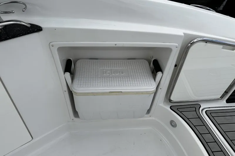 Slide: The Image of Built-in cooler compartment on a 2015 Monterey 264FS boat deck. - 37