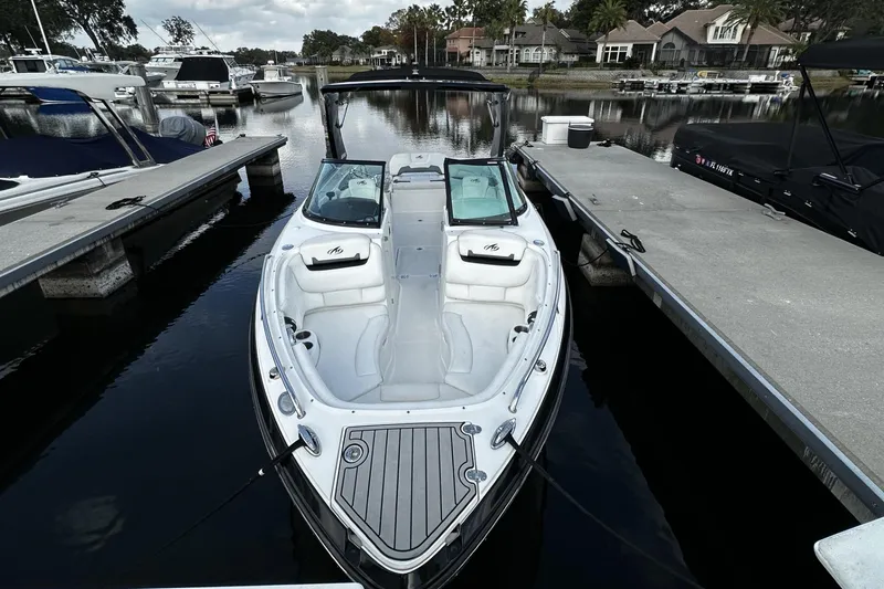 Slide: The Image of 2015 Monterey 264FS boat docked at marina, featuring sleek design and spacious seating. - 45