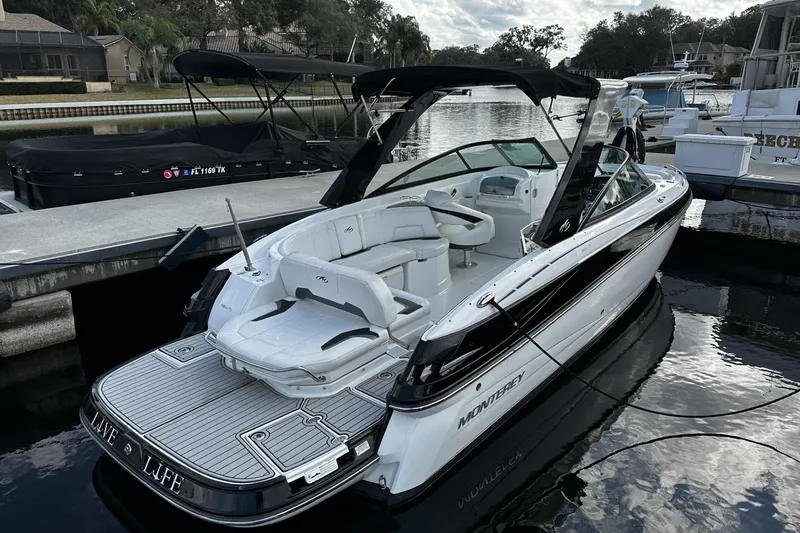 Slide: The Image of 2015 Monterey 264FS boat docked, featuring sleek design and spacious seating. - 6