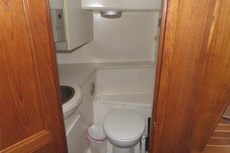 Slide: The Image of Bathroom interior of 1992 Carver 28 Aft Cabin Motor Yacht with wooden door. - 28