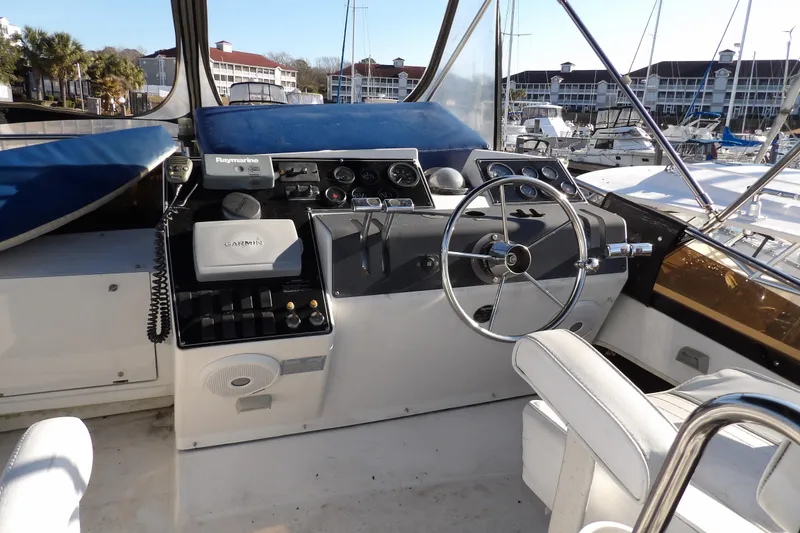 Slide: The Image of 1992 Carver 28 Aft Cabin Motor Yacht helm with steering wheel and navigation equipment. - 8