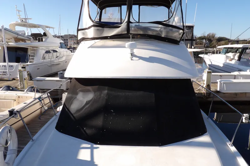 Slide: The Image of 1992 Carver 28 Aft Cabin Motor Yacht docked at marina, front view. - 6