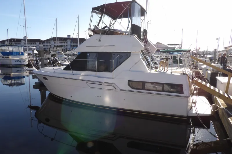 Slide: The Image of 1992 Carver 28 Aft Cabin Motor Yacht docked at marina with dog on deck. - 3