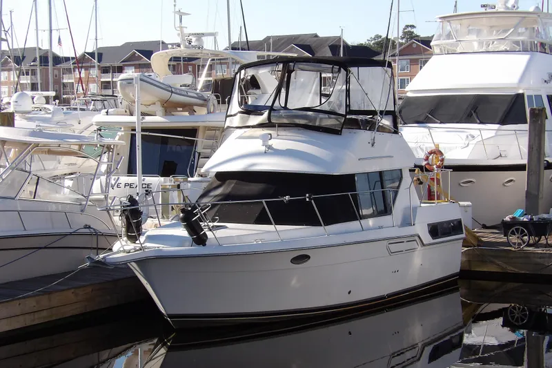 Slide: The Image of 1992 Carver 28 Aft Cabin Motor Yacht docked at marina, surrounded by other boats. - 1