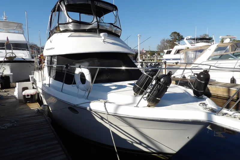 Slide: The Image of 1992 Carver 28 Aft Cabin Motor Yacht docked at marina under clear blue sky. - 2