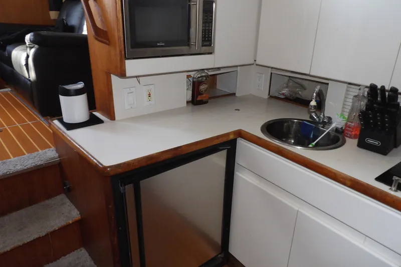 Slide: The Image of 1992 Carver 28 Aft Cabin Motor Yacht kitchen with sink, microwave, and countertop. - 20
