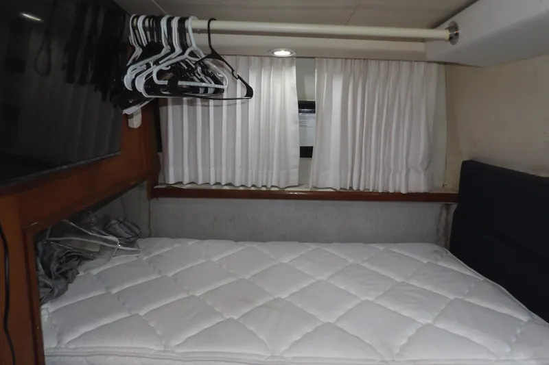 Slide: The Image of Interior cabin of 1992 Carver 28 Aft Cabin Motor Yacht with bed and hangers. - 25