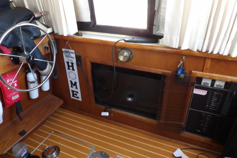 Slide: The Image of Interior of 1992 Carver 28 Aft Cabin Motor Yacht with helm, wood paneling, and decor. - 17