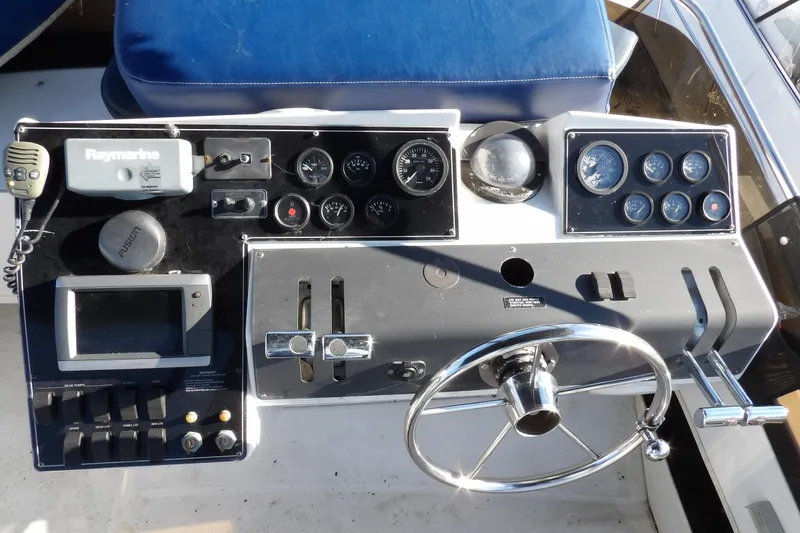 Slide: The Image of 1992 Carver 28 Aft Cabin Motor Yacht dashboard with navigation instruments and steering wheel. - 10
