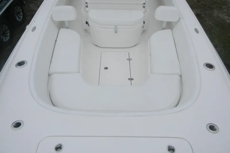 Slide: The Image of 2020 Contender 25 Bay boat interior with white seating and storage compartments. - 13
