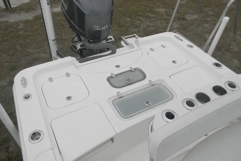 Slide: The Image of 2020 Contender 25 Bay boat deck with Yamaha 300 engine, featuring storage compartments and rod holders. - 15