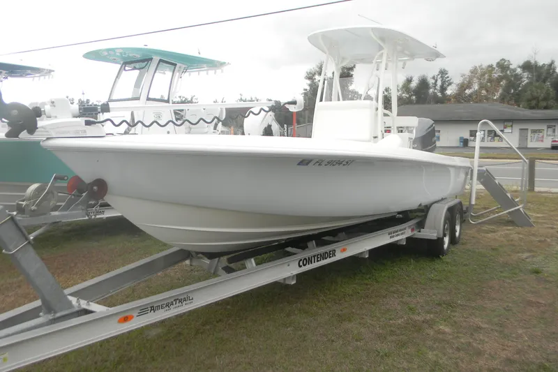Slide: The Image of 2020 Contender 25 Bay boat on trailer, parked outdoors. - 2