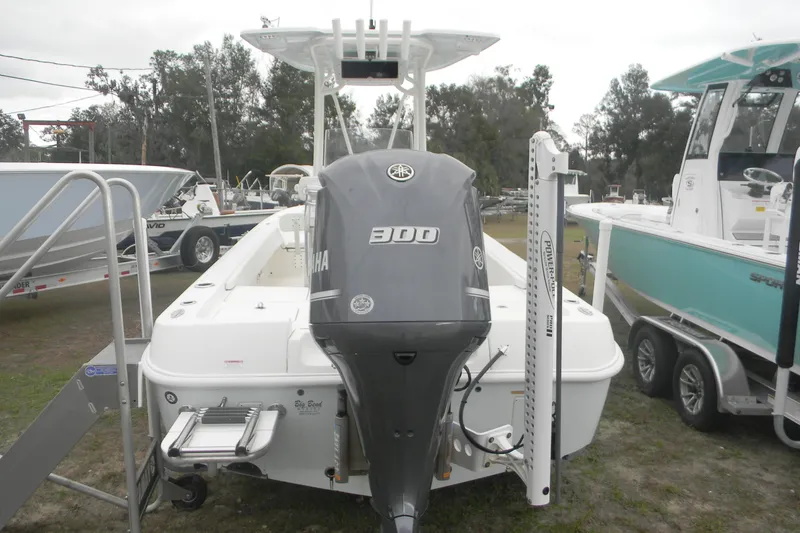 Slide: The Image of 2020 Contender 25 Bay boat with Yamaha 300 engine, displayed outdoors. - 4