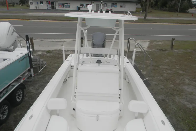 Slide: The Image of 2020 Contender 25 Bay boat, white interior, parked near a road. - 6