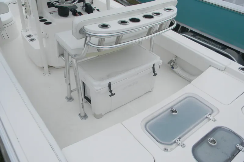 Slide: The Image of 2020 Contender 25 Bay boat interior with seating, rod holders, and storage compartments. - 8