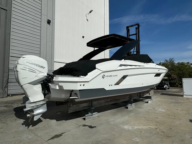 Slide: The Image of 2019 Cruisers Yachts 338 Outboard, white, docked outdoors, featuring twin Mercury engines. - 4