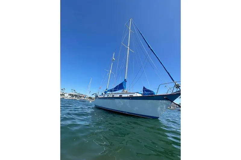 The Image of Sailboat Glen L 44, 2006 model, anchored in calm waters under clear blue sky. - 1