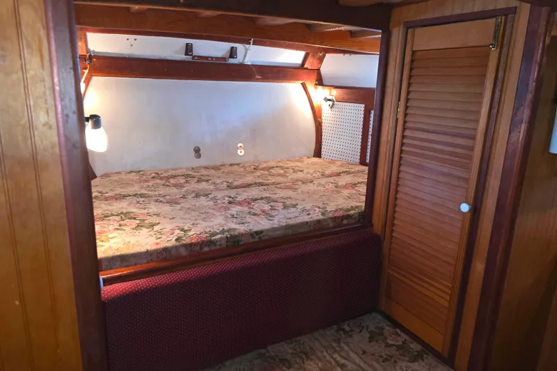 Slide: The Image of Cozy cabin interior of 2006 Glen-L 44 boat with floral bedding and wooden accents. - 14