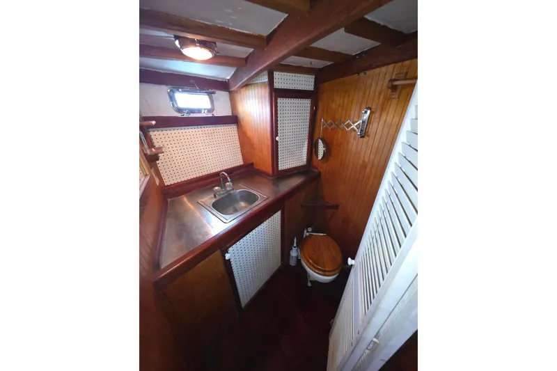 Slide: The Image of Small wooden boat bathroom with sink and toilet, Glen-L 44, 2006 model. - 16