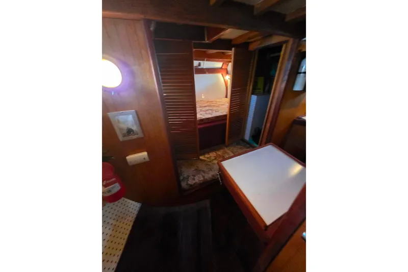 Slide: The Image of Cozy interior of 2006 Glen-L 44 boat with wooden furnishings and bed. - 19