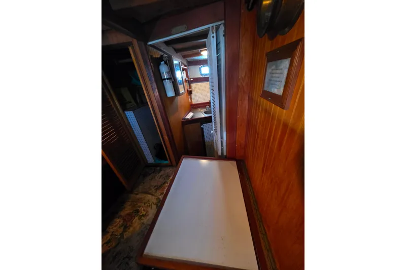 Slide: The Image of Interior of 2006 Glen-L 44 boat with wooden paneling and compact layout. - 20