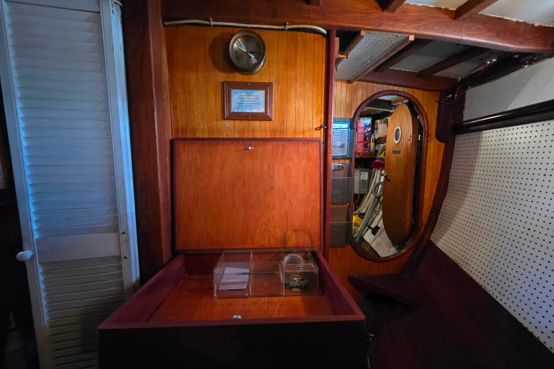 Slide: The Image of Interior of 2006 Glen-L 44 boat with wooden paneling and storage area. - 21