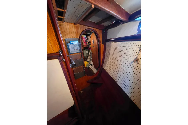 Slide: The Image of Interior of 2006 Glen-L 44 boat with wooden paneling and storage compartments. - 22