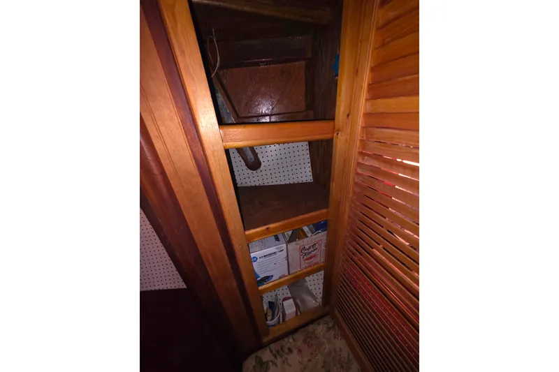 Slide: The Image of Wooden shelving inside Glen-L 44 boat, 2006 model, with storage items. - 25