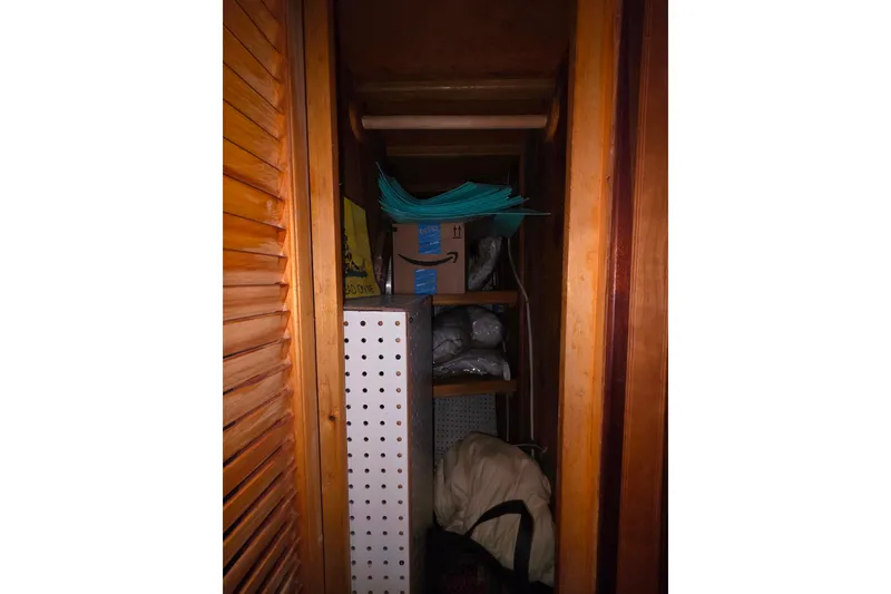 Slide: The Image of Small wooden closet with shelves, storage boxes, and pegboard, Glen-L 44, 2006 model. - 26