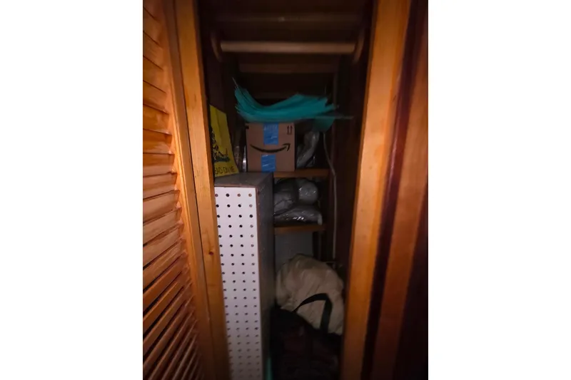 Slide: The Image of Narrow wooden storage space with shelves, boxes, and miscellaneous items, Glen-L 44, 2006. - 28