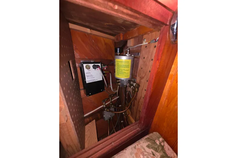 Slide: The Image of Electrical panel and components inside a 2006 Glen-L 44 boat's wooden interior compartment. - 29