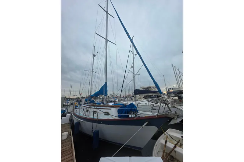 Slide: The Image of Sailboat Glen L 44, 2006 model, docked at marina with overcast sky. - 3