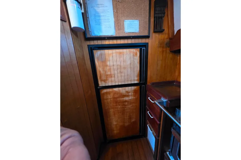 Slide: The Image of Wood-paneled interior of 2006 Glen-L 44 boat with fridge and stove. - 30
