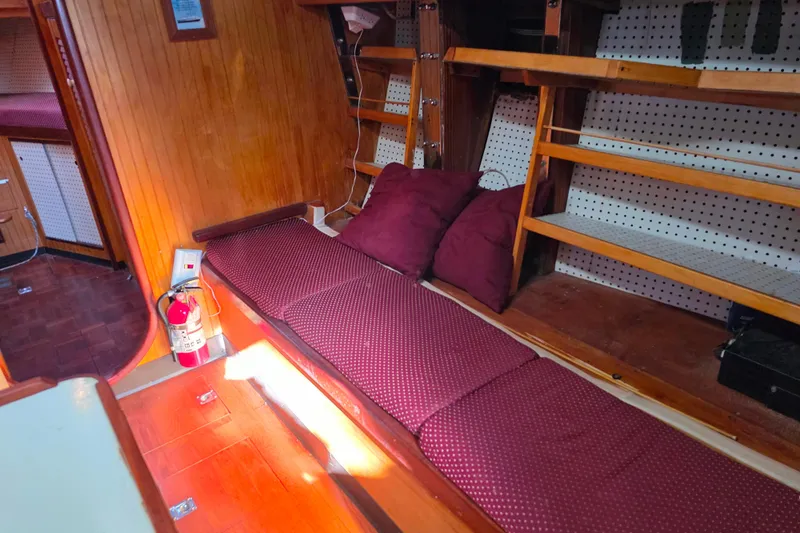 Slide: The Image of Interior of 2006 Glen-L 44 boat with wooden paneling and maroon cushions. - 40