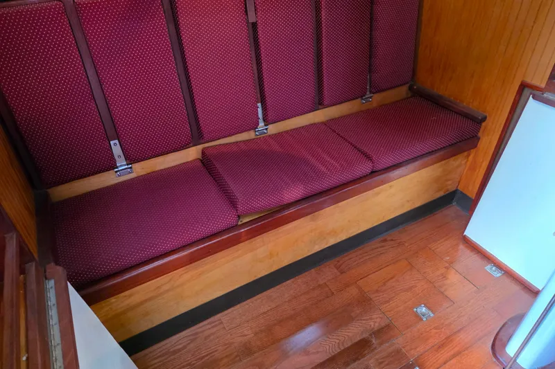 Slide: The Image of Red cushioned seating on wooden floor inside 2006 Glen-L 44 boat. - 41
