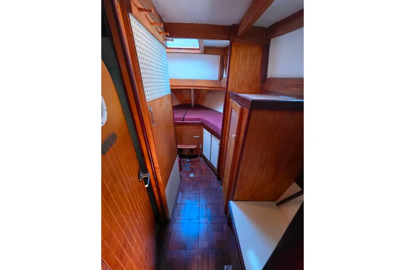 Slide: The Image of Interior of 2006 Glen-L 44 boat, featuring wooden paneling and cozy cabin space. - 48