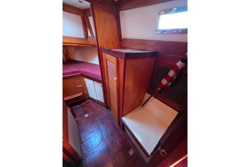 Slide: The Image of Cozy wooden interior of 2006 Glen-L 44 boat cabin with seating and storage. - 49