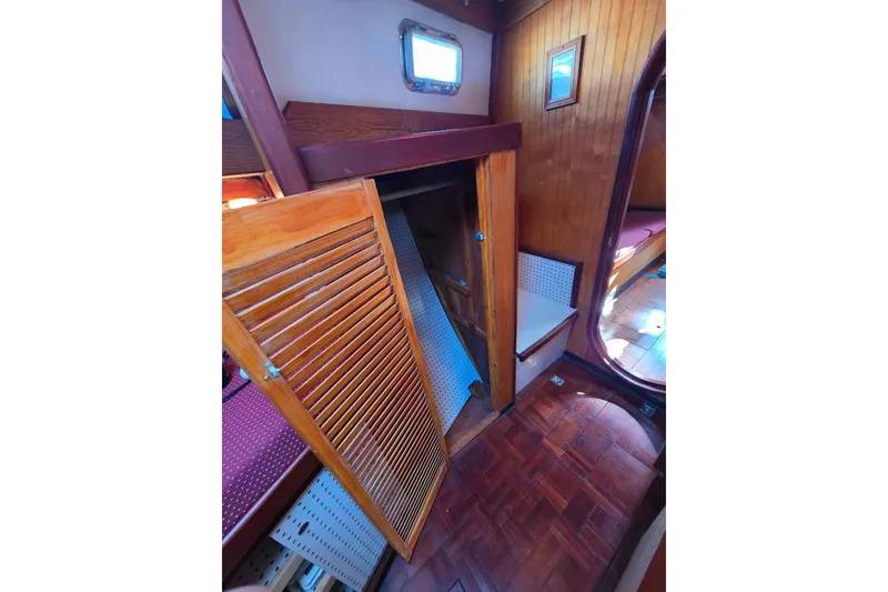 Slide: The Image of Interior of 2006 Glen-L 44 boat with wooden paneling and open closet door. - 51