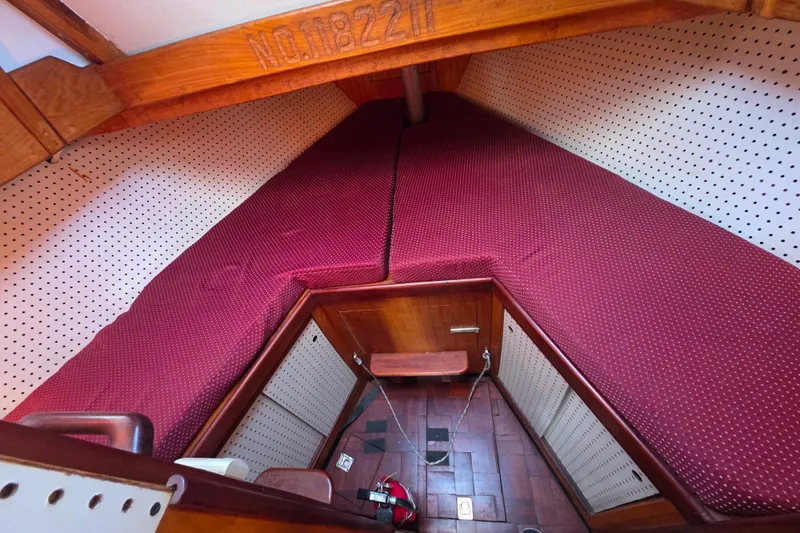 Slide: The Image of Cozy cabin interior of 2006 Glen-L 44 boat with red cushions and wooden accents. - 57