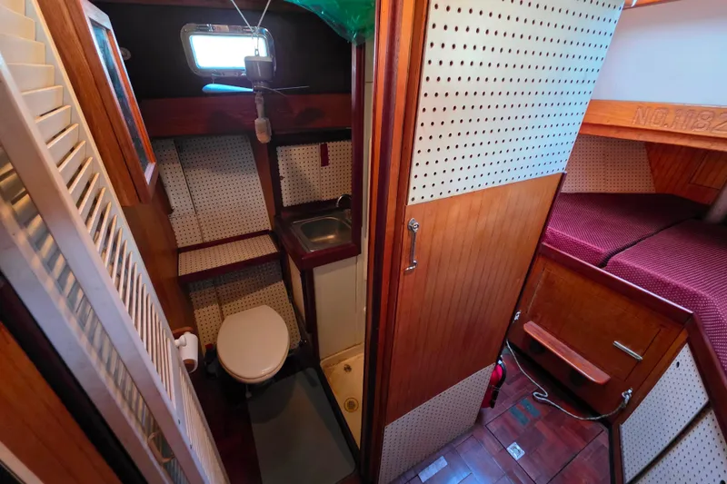 Slide: The Image of Interior of 2006 Glen-L 44 boat featuring compact bathroom and cozy sleeping area. - 62