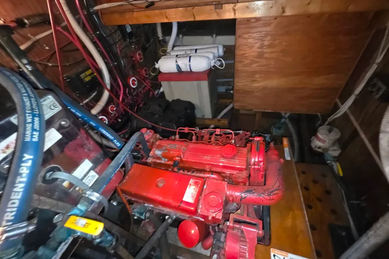 Slide: The Image of Engine room of a 2006 Glen-L 44 boat with red machinery and wiring. - 63